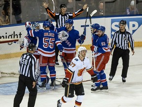 Calgary's Dougie Hamilton skates away as the Rangers celebrate a 4-3 victory over the Flames at Madison Square Garden in New York on Friday night.