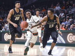 Miami's Chris Lykes tries to get past Wake Forest's Bryant Crawford during the first half of an NCAA college basketball game in Coral Gables, Fla., Wednesday, Feb. 7, 2018.