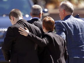 Family and friends console each other as they arrive for the funeral of Meadow Pollack, a victim of the Wednesday shooting at Marjory Stoneman Douglas High School, in Parkland, Fla., Friday, Feb. 16, 2018. Nikolas Cruz, a former student, was charged with 17 counts of premeditated murder.