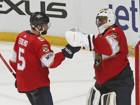 Florida Panthers goaltender Roberto Luongo (1) celebrates a victory over the Pittsburgh Penguins with defenseman Aaron Ekblad (5) after the third period of an NHL hockey game, Saturday, Feb. 24, 2018, in Sunrise, Fla.