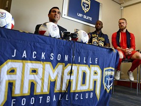 FILE - In this May 4, 2017, file photo, Rishi Sehgal, left, the interim commissioner of the North American Soccer League (NASL), talks about the Jacksonville Armada FC and the search for local ownership as players Jemal Johnson, Caleb Patterson-Sewell, right, listen during a press conference in Jacksonville, Fla. The North American Soccer League canceled its 2018 season after a federal court appeals court denied its attempt to maintain second-tier status, the league announced Tuesday, Feb. 27, 2018. Three NASL teams, the Jacksonville Armada, Miami FC and the New York Cosmos, intend to play this year in the National Premier Soccer League, which has not been designated as part of the USSF soccer pyramid.