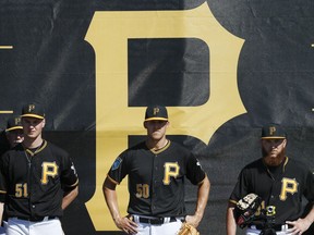 Pittsburgh Pirates pitchers Jordan Milbrath (51), Jameson Taillon (50), and A.J. Schugel, right, stand in the bullpen during baseball spring training Friday, Feb. 16, 2018, in Bradenton, Fla.