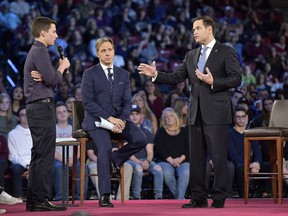 In this Feb. 21, 2018 photo, Marjory Stoneman Douglas High School student Cameron Kasky asks a question to Sen. Marco Rubio during a CNN town hall meeting at the BB&T Center in Sunrise, Fla.  Red, blue or purple, in flyover country or along the U.S. coast, most Americans loathe the national legislature and think its members are listening to all the wrong people.