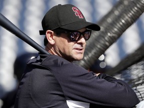 New York Yankees manager Aaron Boone wears a hat honoring the victims of the shooting at Marjory Stoneman Douglas High School as he watches batting practice before a spring training baseball game against the Detroit Tigers, Friday, Feb. 23, 2018, in Tampa, Fla.