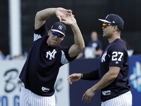 New York Yankees' Aaron Judge, left, and Giancarlo Stanton stretch at baseball spring training camp, Monday, Feb. 19, 2018, in Tampa, Fla.