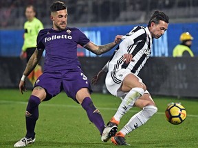 Fiorentina's Cristiano Biraghi and Juventus' Federico Bernardeschi, right, go for the ball during a Serie A soccer match between Fiorentina and Juventus at the Artemio Franchi stadium in Florence, Italy, Friday, Feb. 9, 2018.