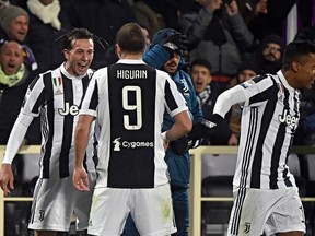 Juventus' Federico Bernardeschi, left, celebrates with teammate Gonzalo Higuain after scoring during a Serie A soccer match between Fiorentina and Juventus at the Artemio Franchi stadium in Florence, Italy, Friday, Feb. 9, 2018.