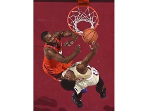 Clemson forward Aamir Simms, left, fouls Florida State guard Terance Mann as he attempts a dunk during the first half of an NCAA college basketball game Wednesday, Feb. 14, 2018, in Tallahassee, Fla.