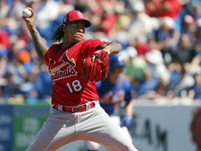 St. Louis Cardinals starting pitcher Carlos Martinez throws during the first inning of an exhibition spring training baseball game against the New York Mets, Saturday, Feb. 24, 2018, in Port St. Lucie, Fla.