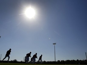 Members of the Washington Nationals run sprints during spring training baseball practice Saturday, Feb. 17, 2018, in West Palm Beach, Fla.