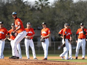 Miami Marlins pitcher Sandy Alcantara stands on the mound as teammates wait their turn during a drill during spring training baseball practice Sunday, Feb. 18, 2018, in Jupiter, Fla.
