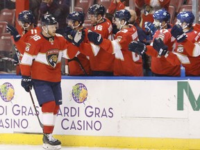 Florida Panthers left wing Jamie McGinn (88) is congratulated by teammates after he scored during the first period of an NHL hockey game against the Vancouver Canucks, Tuesday, Feb. 6, 2018, in Sunrise, Fla.