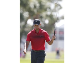 Tiger Woods acknowledges the crowd after putting on the second hole during the final round of the Honda Classic golf tournament, Sunday, Feb. 25, 2018, in Palm Beach Gardens, Fla.