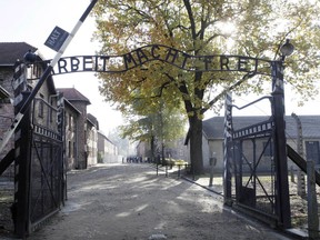 FILE - This Oct. 19, 2012 file photo shows the gate of the former Nazi death camp of Auschwitz in Oswiecim, Poland. The office of Polish President Andrzej Duda said the leader will on Tuesday, Feb. 6, 2018 announce his decision on whether to sign legislation penalizing certain statements about the Holocaust.