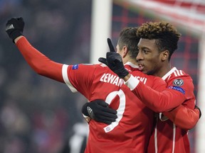 Bayern's Robert Lewandowski, left, congratulates Kingsley Coman who scored their second goal during the Champions League round of 16 first leg soccer match between Bayern Munich and Besiktas Istanbul in Munich, southern Germany, Tuesday, Feb. 20, 2018.