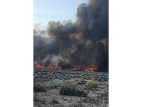 This Sunday, Feb. 18, 2018 photo released by the Inyo County Sheriff's Office shows smoke rising from wildfires near Bishop, Calif. A wind-driven wildfire in rural central California forced mandatory evacuations and threatened hundreds of buildings Monday, including a historic railroad station, after it tripled in size overnight, officials said. (Inyo County Sheriff's Office via AP)