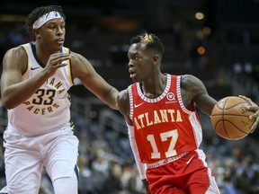 Indiana Pacers center Myles Turner (33) defends against Atlanta Hawks guard Dennis Schroeder (17) during the first half of an NBA basketball game Wednesday, Feb. 28, 2018, in Atlanta.
