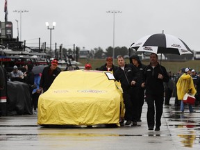 NASCAR Cup Series driver Joey Logano's car is pushed during a rain shower before the NASCAR Cup Series auto race at Atlanta Motor Speedway in Hampton, Ga., Sunday, Feb. 25, 2018.