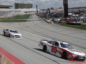 Christopher Bell (20) leads Cole Custer (00) during the NSCAR Xfinity series auto race at Atlanta Motor Speedway in Hampton, Ga., on Saturday, Feb. 24, 2018.