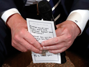 President Donald Trump holds his notes during a listening session on gun violence with high school students, teachers and parents at the White House on Feb. 21, 2018.