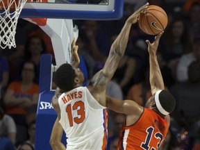 Florida forward Kevarrius Hayes (13) blocks a shot by Auburn forward Desean Murray (13) during the first half of an NCAA college basketball game in Gainesville, Fla., Saturday, Feb. 24, 2018.