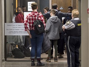 Visitors pass through security as they attend Federal Court for a hearing to determine whether deportation proceedings should be halted for Abdoul Abdi, the former child refugee, in Halifax on Thursday, Feb. 15, 2018. The federal government wants to send Abdi back to Somalia because of his criminal history and his lack of Canadian citizenship.