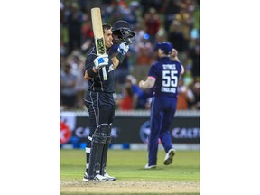 New Zealand's Ross Taylor, left, celebrates his 100 runs during a One Day International cricket match against England in Hamilton, New Zealand, Sunday, Feb. 25, 2018.