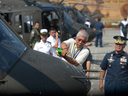Philippine defence secretary Voltaire Gazmin pours champagne over the nose of a Bell 412 helicopter in a christening ceremony as Philippine Air Force chief Lieutenant General Jeffrey Delgado watches in Manila on Aug. 17, 2015.