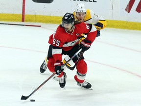 Ottawa Senators defenceman Erik Karlsson keeps the puck from Nashville Predators forward Kyle Turris on Feb.
 8.