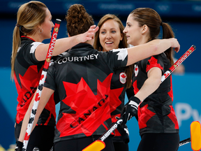 Rachel Homan hugs her teammates after they beat Switzerland during  women's curling.