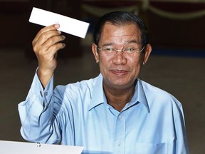 Cambodian Prime Minister Hun Sen of ruling Cambodian People's Party shows off a ballot paper before voting for senate election at Takhmau polling station in Kandal province, southeast of Phnom Penh, Cambodia, Sunday, Feb. 25, 2018. Cambodia's ruling party is assured of a sweeping victory in the election of a new Senate after the only real opposition to it was eliminated.