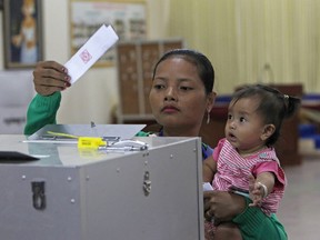 Cambodian woman votes a ballot for the senate election at Takhmau polling station in Kandal province, southeast of Phnom Penh, Cambodia, Sunday, Feb. 25, 2018. Cambodia's ruling party is assured of a sweeping victory in the election of a new Senate after the only real opposition to it was eliminated.