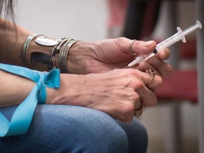 A woman injects hydromorphone at the Providence Health Care Crosstown Clinic in the Downtown Eastside of Vancouver, B.C., on April 6, 2016.