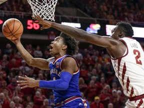 Kansas' Devonte' Graham (4) goes to the basket in front of Iowa State's Cameron Lard (2) during the second half of an NCAA college basketball game in Ames, Iowa, Tuesday, Feb. 13, 2018. Kansas won 83-77.
