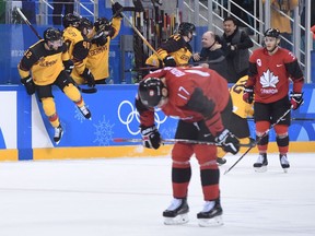 German players celebrate their Olympic men's hockey semifinal win over Canada on Feb. 23, 2018.