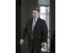 In a  Friday, Nov. 16, 2012 photo, former Chicago police officer Joseph Frugoli heads into the Criminal Courts Building in Chicago to be sentenced for causing a crash that killed two while he was driving drunk off-duty. A Chicago City Council committee is expected on Monday, Feb. 26, 2018 to recommend a $20 million payout to the families of two men who were killed when Frugoli slammed into their car nine years ago.