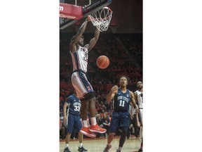 Illinois forward Kipper Nichols (2) dunks over Penn State forward Lamar Stevens (11) during the first half of an NCAA college basketball game in Champaign, Ill., on Sunday, Feb.11, 2018.