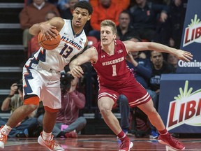 Illinois guard Mark Smith (13) grabs  the ball away from Wisconsin guard Brevin Pritzl (1) during the first half of an NCAA college basketball game in Champaign, Ill., on Thursday, Feb. 8, 2018.