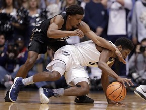 Xavier guard Quentin Goodin, top, and Butler guard Kamar Baldwin (3) go for a loose ball during the first half of an NCAA college basketball game in Indianapolis, Tuesday, Feb. 6, 2018.