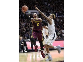 Minnesota guard Nate Mason, left, shoots over Purdue forward Vincent Edwards, right,  in the first half of an NCAA college basketball game in West Lafayette, Ind., Sunday, Feb. 25, 2018.