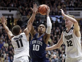 Penn State guard Tony Carr (10) shoots between Purdue guard P.J. Thompson (11) and forward Matt Haarms (32) in the first half of an NCAA college basketball game in West Lafayette, Ind., Sunday, Feb. 18, 2018.