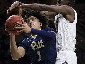 Pittsburgh's Parker Stewart (1) goes up for a shot with pressure from Notre Dame's T.J. Gibbs during the first half of an NCAA college basketball game Wednesday, Feb. 28, 2018, in South Bend, Ind.