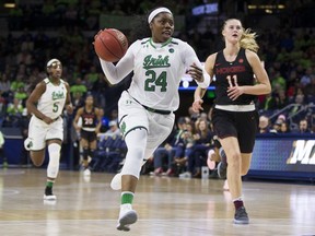 Notre Dame's Arike Ogunbowale (24) drives downcourt in front of Virginia Tech's Regan Magarity (11) during the first half of an NCAA college basketball game Thursday, Feb. 22, 2018, in South Bend, Ind.