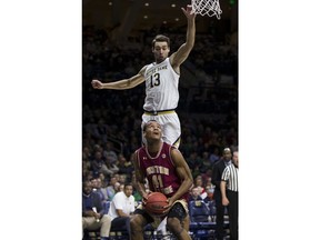 Boston College's Steffon Mitchell (41) fakes a shot under the basket in front of Notre Dame's Nikola Djogo (13) during the first half of an NCAA college basketball game Tuesday, Feb. 6, 2018, in South Bend, Ind.