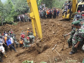 Rescuers recover the body of a victim of a landslide in Cijeruk, West Java, Indonesia, Tuesday, Feb. 6, 2018. Seasonal downpours cause dozens of landslides and flash floods each year in Indonesia, an archipelago of more than 17,000 islands where millions of people live in mountainous areas or on flood plains. (AP Photo)