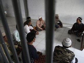 FILE - In this June 6, 2011, file photo, inmates attend a religious class led by convicted militant Arif Syaifudin, right, in Porong Prison in Sidoarjo, East Java. Indonesia's overcrowded prisons are ill-equipped to deal with Islamic militant inmates, hampering efforts to prevent the spread of violent radicalism, a new study has found, adding to years of warnings by experts that the country's prisons have become a jihadist training ground.