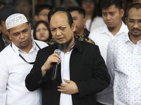 Indonesian Corruption Eradication Commission investigator Novel Baswedan, center, delivers a speech upon arrival at the commission's headquarters in Jakarta, Indonesia, Thursday, Feb. 22, 2018. The anti-corruption investigator blinded by an acid attack is urging graft fighters to "stay brave" as he returns to Indonesia after months of medical treatment.