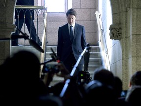 Prime Minister Justin Trudeau walks down the stairs to Question Period into the House of Commons on Parliament Hill in Ottawa on Monday, Feb. 12, 2018.