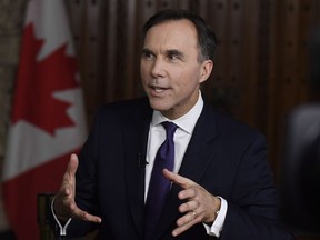 Minister of Finance Bill Morneau participates in a TV interview after tabling the budget in the House of Commons on Parliament Hill in Ottawa on Tuesday, Feb. 27, 2018.