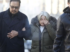 Thelma Favel, centre, Tina Fontaine's great-aunt and the woman who raised her, weeps as she enters the law courts in Winnipeg with Chief Kevin Hart and supporters the day the jury delivered a not-guilty verdict in the second degree murder trial of Raymond Cormier, Thursday, February 22, 2018.